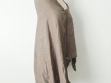 a woman standing on a mannequin wearing a gray shirt