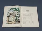 un livre ouvert sur lequel figure l'image d'une maison