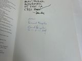 a book with a handwritten note on it sitting on a table