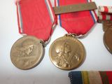 three medals and a ribbon are sitting on a table