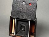 an old photo of an old camera with a wooden box