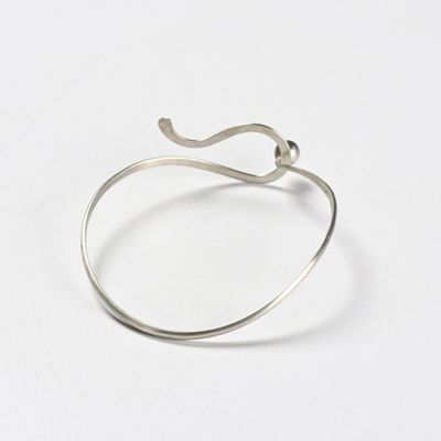 a close up of a silver ring on a white surface