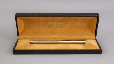 a silver ballpoint pen in a black box with gold trim