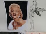 a drawing of a woman on a desk next to a drawing of a woman
