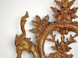 a large ornate gold frame with birds and flowers on it