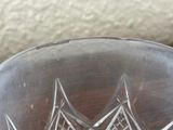 a glass bowl with a design on it on a table