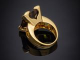 a close up of a gold ring with a black stone