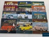 several books of old cars are stacked on top of each other