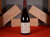 a bottle of red wine sitting on a table