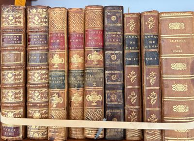 many old books sitting on a shelf in a room