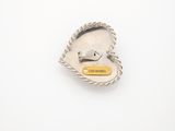 a silver buckle with a yellow tag on it
