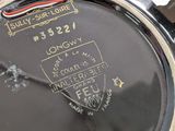 a close up of a black watch with a red strap on it