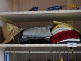 a closet with a lot of clothes and hats on the shelves