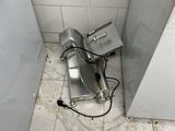 a broken toilet in the corner of a bathroom