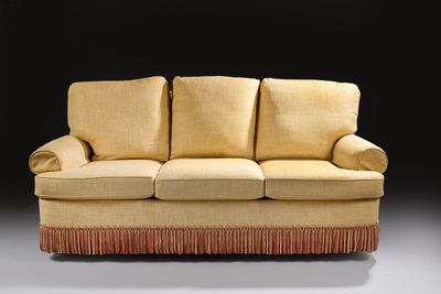 an image of a couch with a red fringe on it