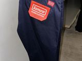 a pair of blue pants hanging on a clothes rack