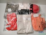 many bags of clothing and a hat on a table