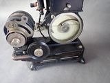 a black and white photo of an old movie projector