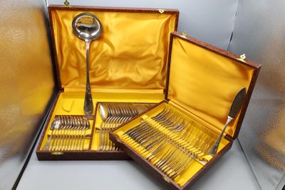 a wooden case with silverware in it on a table
