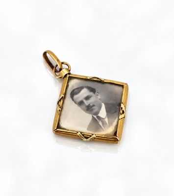 an old photo of a man in a suit and tie in a gold frame