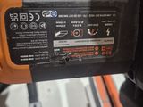 an orange and black electric driller sitting on top of a table