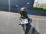 a motorcycle parked in a parking lot with a license plate on it