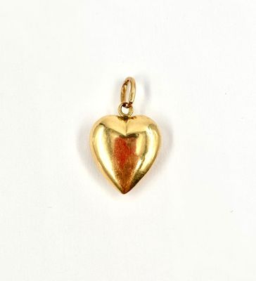 an image of a gold heart charm on a white background