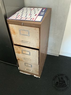 a filing cabinet with a file cabinet on top of it