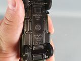 a person holding a toy car in their hand