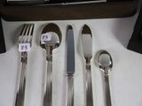 a lot of silverware on a table with a price tag on it