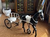 a toy horse pulling a carriage in a living room