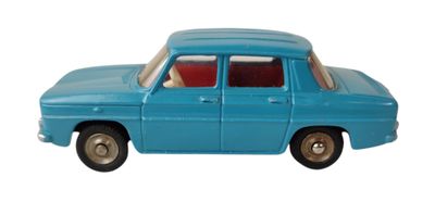 une petite voiture bleue posée sur une surface blanche
