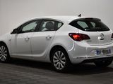 the back end of a white car parked in a room