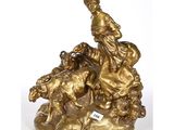 bronze statue of a woman on a rock with dogs and sheep