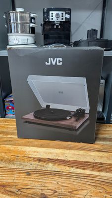 an open box of a record player sitting on top of a wooden table