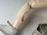 a pair of shoes and a wooden leg with a cast on it