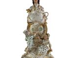 a figurine of a woman holding a bowl and a plate