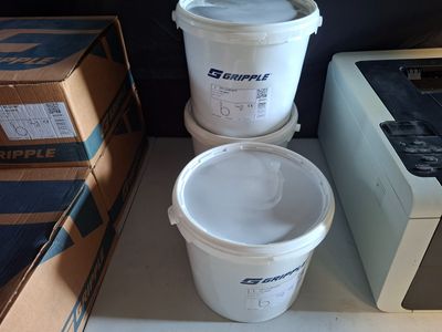 three buckets of water sitting on a shelf next to a microwave
