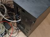 a computer on the floor with wires all around it