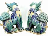 two figurines of a horse and a horse with a bird on it
