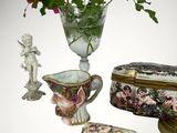 a vase with flowers in it sitting next to other items