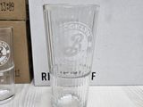 a clear glass sitting on a table next to a box