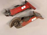 pair of red and black pipe cutters on a white surface