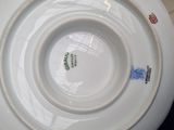a white plate with a design on it sitting on a table