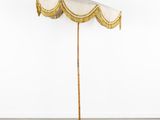 a white umbrella with a gold fringe hanging from the top of it
