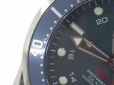 a close up of a wrist watch with a blue face