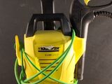 a yellow and black pressurer on a table with a green hose
