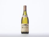 a bottle of white wine sitting on top of a table