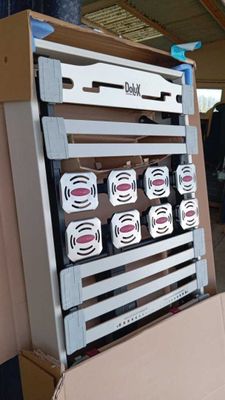 a cardboard box with a bunch of speakers in it