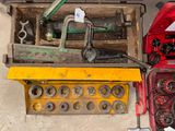 a box of tools sitting on the floor next to other tools
